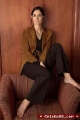 Carrie Anne Moss in brown jacket
