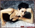 Carrie Anne Moss laying on the floor
