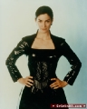Carrie Anne Moss wearing black leather