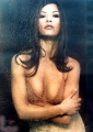 Catherine Zeta Jones posing behind the wet glass