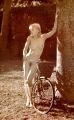 Nude Madonna posing by the old fashioned bicycle