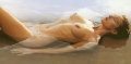 Monica Bellucci posing nude on the beach