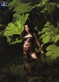 Monica Bellucci posing in black hot dress in the jungle
