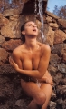 Monica Bellucci posing naked inside stream of pouring water
