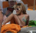 Nicole Richie is sunbathing on the beach