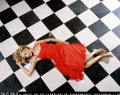 Nicole Richie posing in sexy red dress on the chequered froor