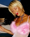 Paris Hilton with a cherry in her mouth wearing pink sexy dress   
