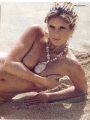 Rachel Hunter posing topless on the beach