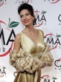 Shania Twain dressed in hot golden dress with plunging neckline