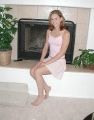 Lacey White posing by the fireplace