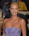 Charlize Theron in violet dress with plunging neckline