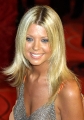 Tara Reid posing in sexy silver dress with plunging neckline