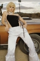 Elisha Cuthbert posing next to muscle car