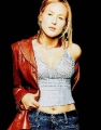 Jewel Kilcher posing in red leather coat