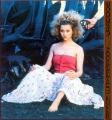 Reese Witherspoon posing in red dress with curly hair