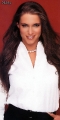 Stephanie McMahon wearing white hot blouse