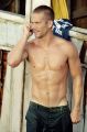 shirtless talking on a phone