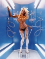 Topless Pamela Anderson is painting herself in Miracle Tan