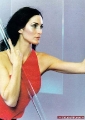 Carrie Anne Moss posing in red dress